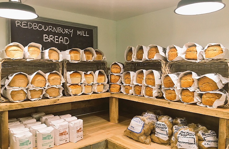 farm shop shelves full of redbournbury bread, bags of potatoes and flour